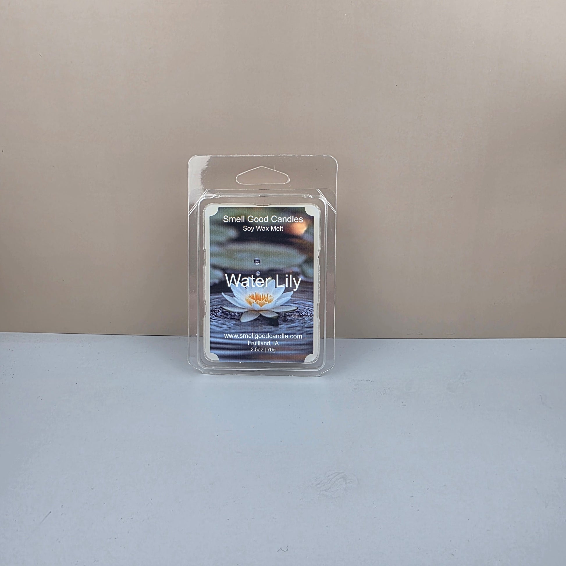 Packaged water lily wax melt on a neutral background